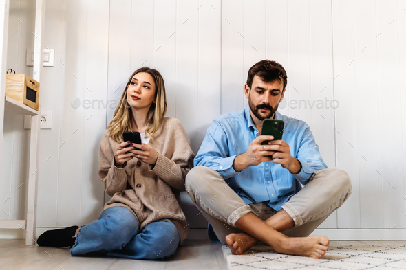 Gadget addiction and relationship problems. Couple with smartphones ignoring each other