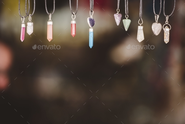 Closeup shot of hexagonal prism necklaces with a blurred background