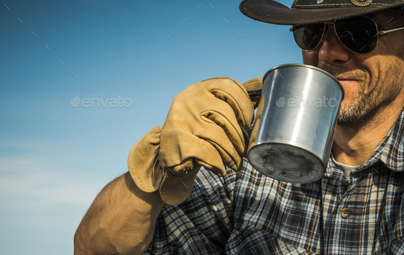 Cowboy Drinking Hot Coffee From His Metal Made Cap