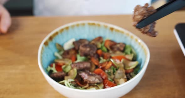 Serving Hot Salad with Meat Colorful Vegetables Cooked By Chef in Restaurant