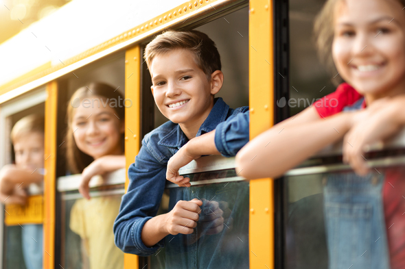 Excited children peeping from the school bus window Stock Photo by ...