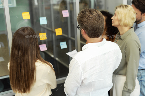 Group of businesspeople using sticky notes, agile methodology for productivity working together