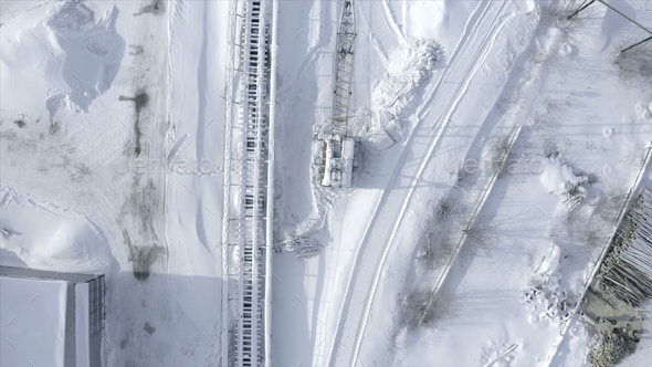 Top view of railway with snow. Clip. Empty snow-covered railway rails in winter. Snow falling on