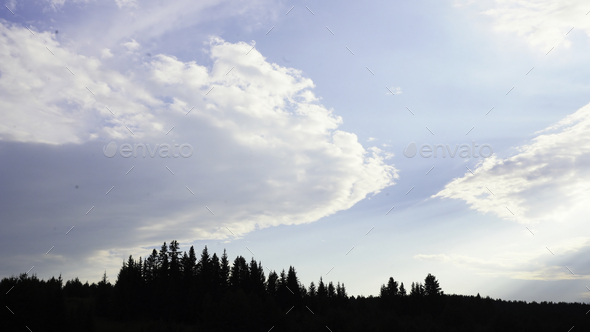 Panorama of cloudy sky with sun and shadow of forest. Media. Overcast clouds with rays of daytime