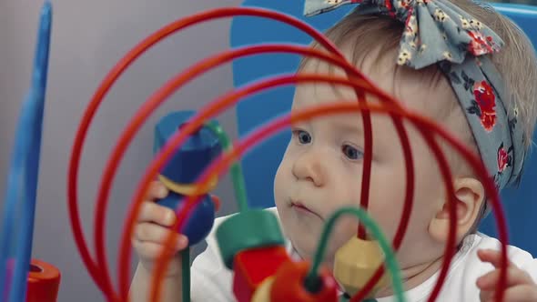 Child Plays with a Multi-colored Toy alt