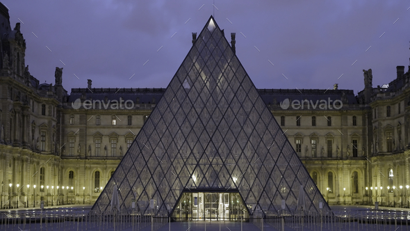 Louvre pyramid, famous landmark and tourist attraction in Paris, France. Action. Concept of tourism.