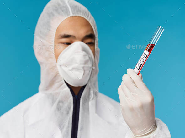 Male laboratory assistant analyzes diagnostics blood testing examination blue background