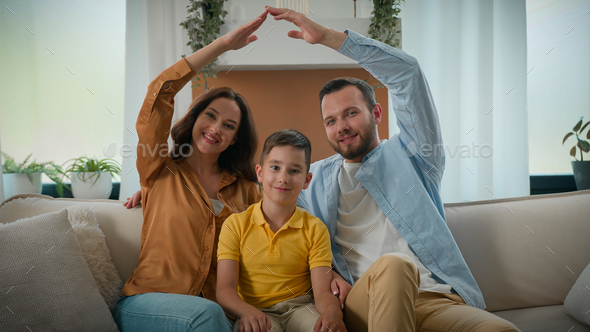 Happy caucasian family affection parents dad mom son kid boy sitting on couch in cozy living room
