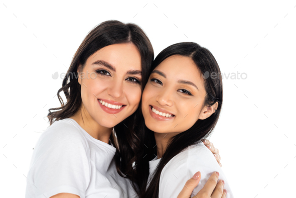 happy brunette woman embracing and looking at camera with asian