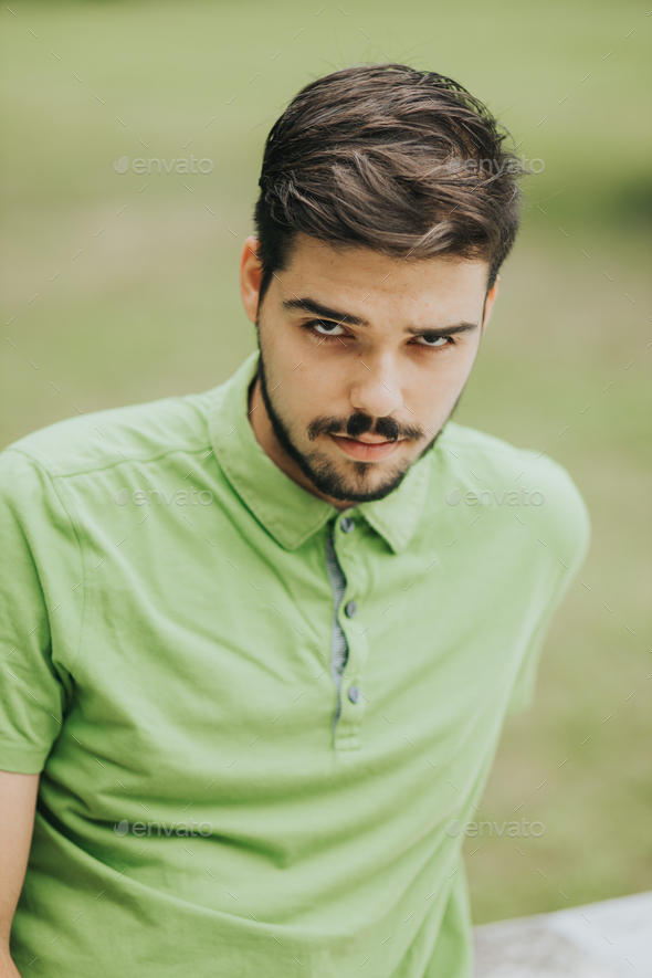 Vertical Portrait Of A Young Attractive Caucasian Male Posing Outdoors