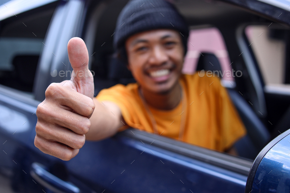 Smiling Online Taxi Driver Showing Thumb Up