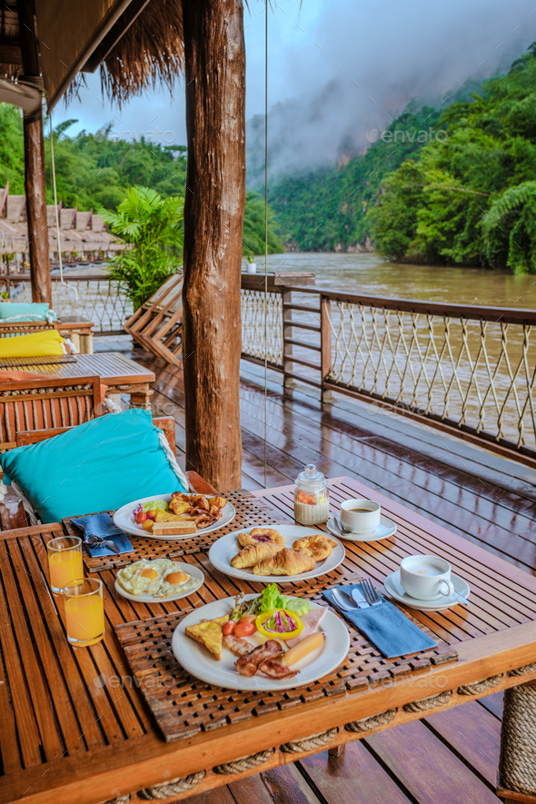 breakfast table at a tropical beach houses on the River Kwai in Thailand