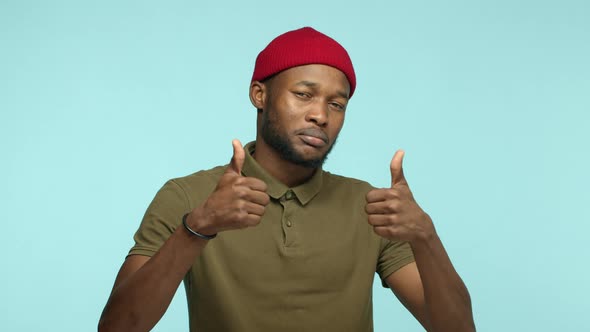 Slow Motion of Cool Black Man with Beard Wearing Red Beanie Looking Impressed with Great Work