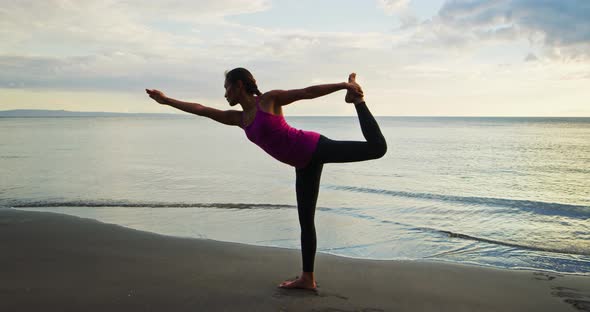 Woman Practicing Yoga at Sunset alt