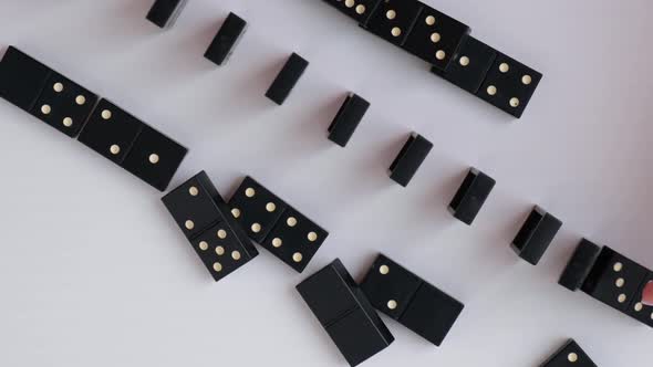 Dominoes Falling in a Row Hand Pushes a Domino and Starts a Chain Reaction Slow Motion alt