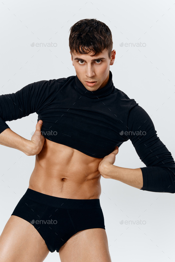 sexy guy in turtleneck sweater and black panties portrait Stock Photo by  shotprime
