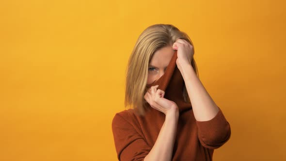 Fresh Looking Model Wearing Turtleneck Sweater in Front of Yellow Background alt