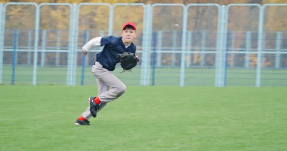 Baseball Tournament at School the Boy Pitcher Run and Successfully Catches a Fastball in the Glove alt