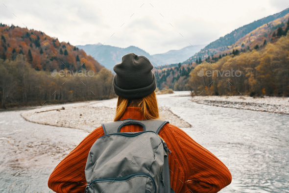 woman in a sweater and cap with a backpack on her back in the