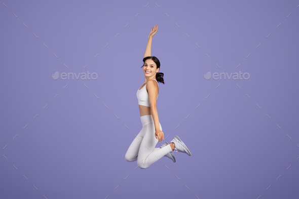 Joyful Fitness Dancer In Sports Attire Leaping With Excitement