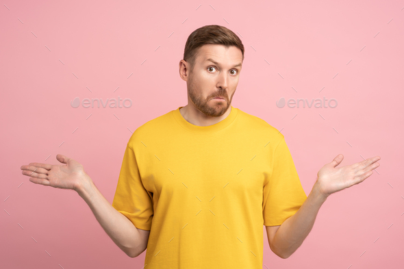 Puzzled confused stunned man gesturing hands sign do not know isolated ...