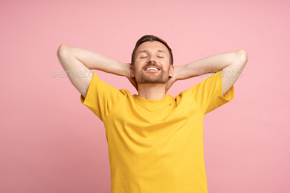 Happy smiling guy on pink background. Contentment, happiness, satisfaction, euphoria, ecstasy.