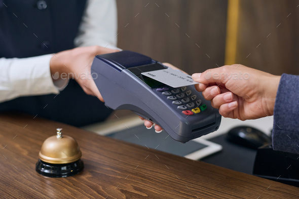 Woman using credit card to pay for room