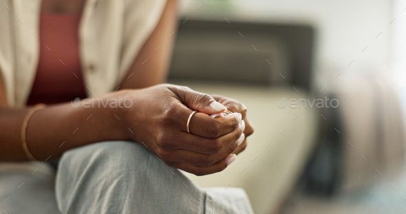 Anxiety, hands and closeup of woman on a sofa with fear, worry or mental health crisis at home. Str
