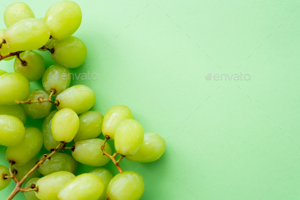 top view of ripe and organic grapes on green Stock Photo by