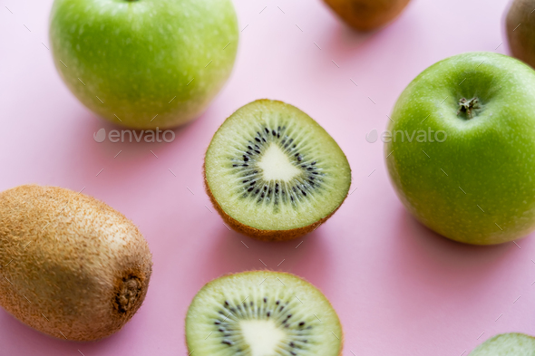 flat lay of organic kiwi fruit on green and pink Stock Photo by  LightFieldStudios