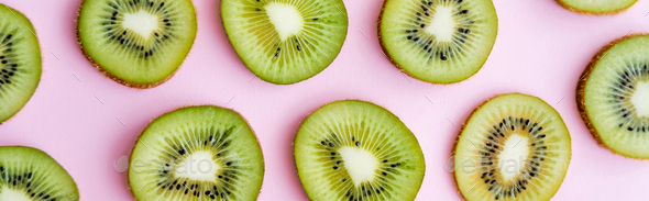 flat lay of organic kiwi fruit on green and pink Stock Photo by  LightFieldStudios