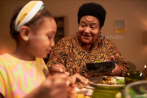 Grandmother Giving Daughter More Salad