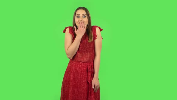 Tender Confused Girl in Red Dress Is Saying Oops and Shrugging. Green Screen alt