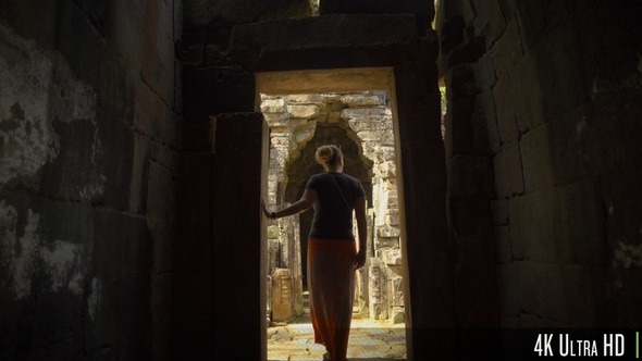 4K Following Back of Woman Walk Through an Ancient Doorway in Angkor Wat alt