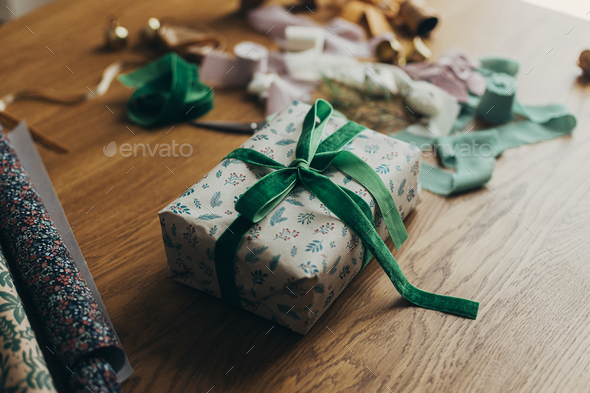 Wrapping christmas gifts. Stylish festive wrapping paper, ribbons