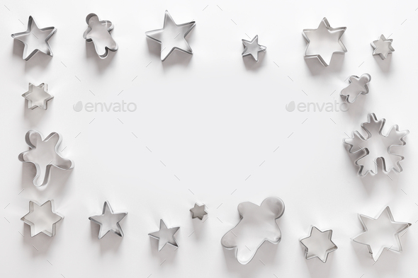 Christmas-themed cookie cutters as frame. Xmas greeting card. Stock