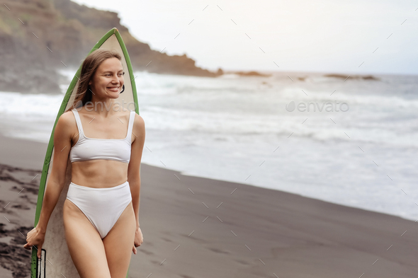 Teenager Girl Wearing Bikini Stands In The Water Of A Beautiful