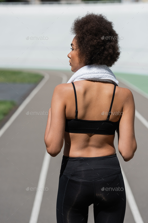 young african-american woman in bright sports bra holding orange juice  Stock Photo by LightFieldStudios