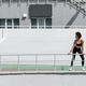 full length of african american woman in black sportswear standing near  sports bottle on city Stock Photo by LightFieldStudios