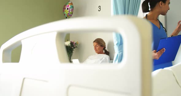 Senior patient being checked by female doctor in the ward alt