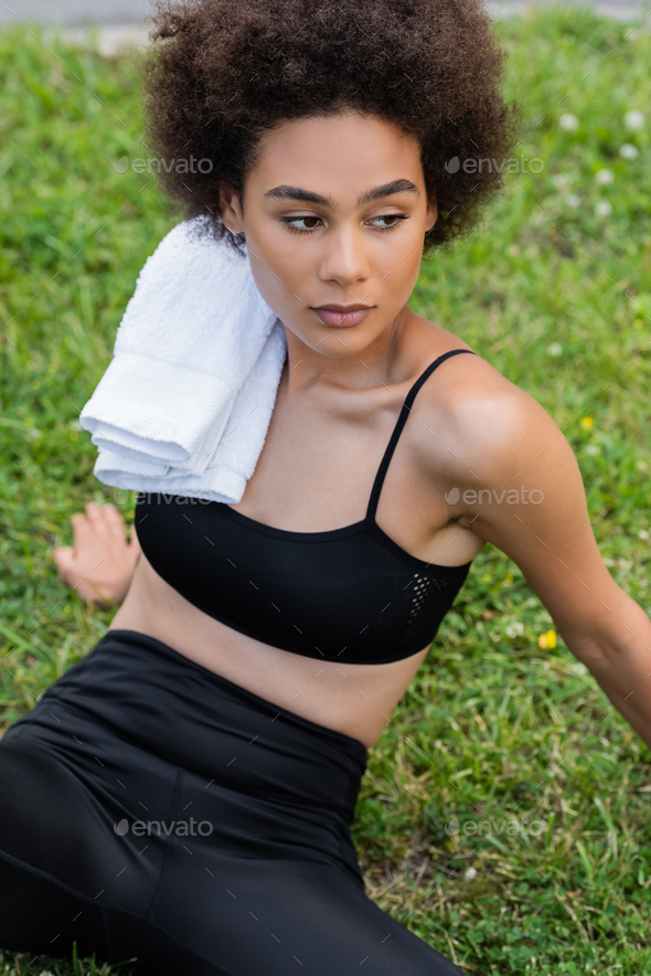 young african-american woman in bright sports bra holding orange juice  Stock Photo by LightFieldStudios