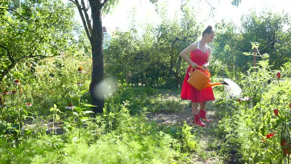 Woman watering plants in a garden