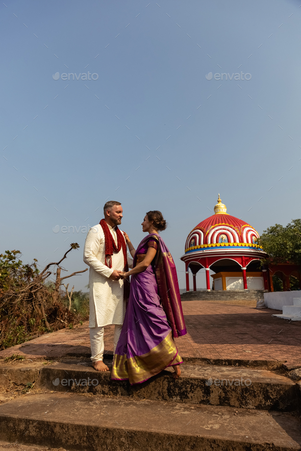 Wedding of a couple from Europe in India. A light skinned man in a traditional Indian men white skin