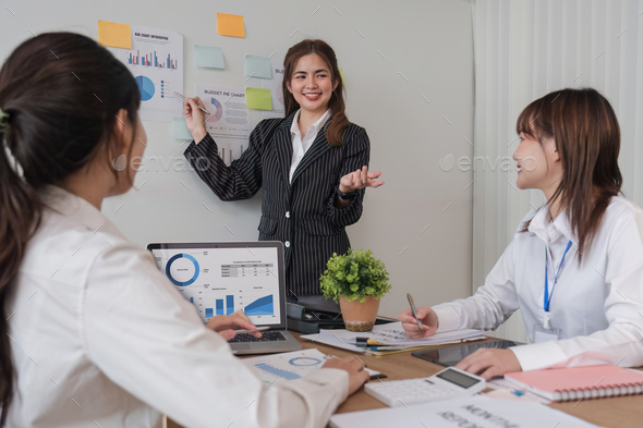 Female Operations Manager Holds Meeting Presentation for a Team of Economists. Asian Woman Uses
