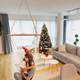 Woman sitting in swing chair and relaxing at home on Christmas day - PhotoDune Item for Sale