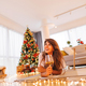 Woman relaxing at home on Christmas day - PhotoDune Item for Sale