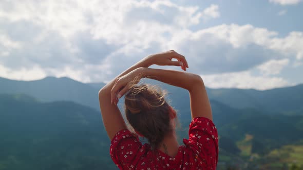 Girl Standing Raising Hands in Mountains Close Up alt