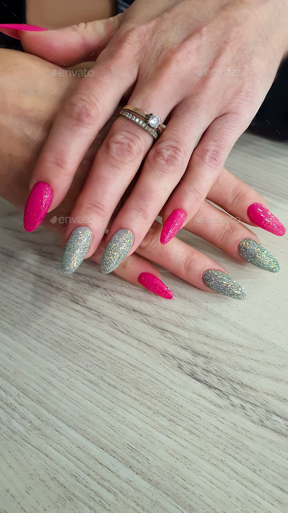 Acrylic nail extensions, manicure, nail correction, hands in the foreground. Reflective design.