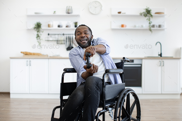 african male gamer with mobility impairment with input devices