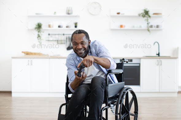 african male gamer with mobility impairment with input devices